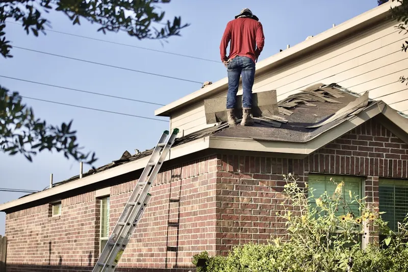 Professional roofer working on a residential roof in Brentwood